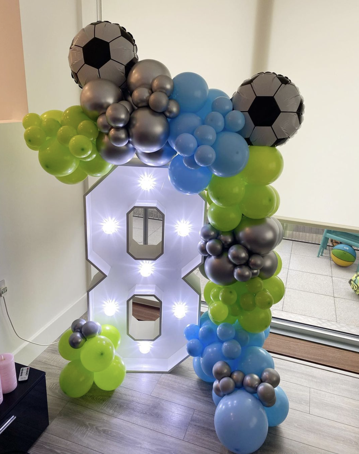 Light up number Light up number 8 with football theme blue and green balloon garland